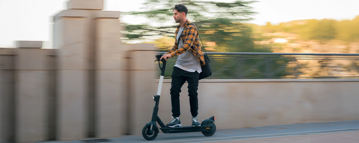 Mann fährt auf schnell auf E-Scooter
